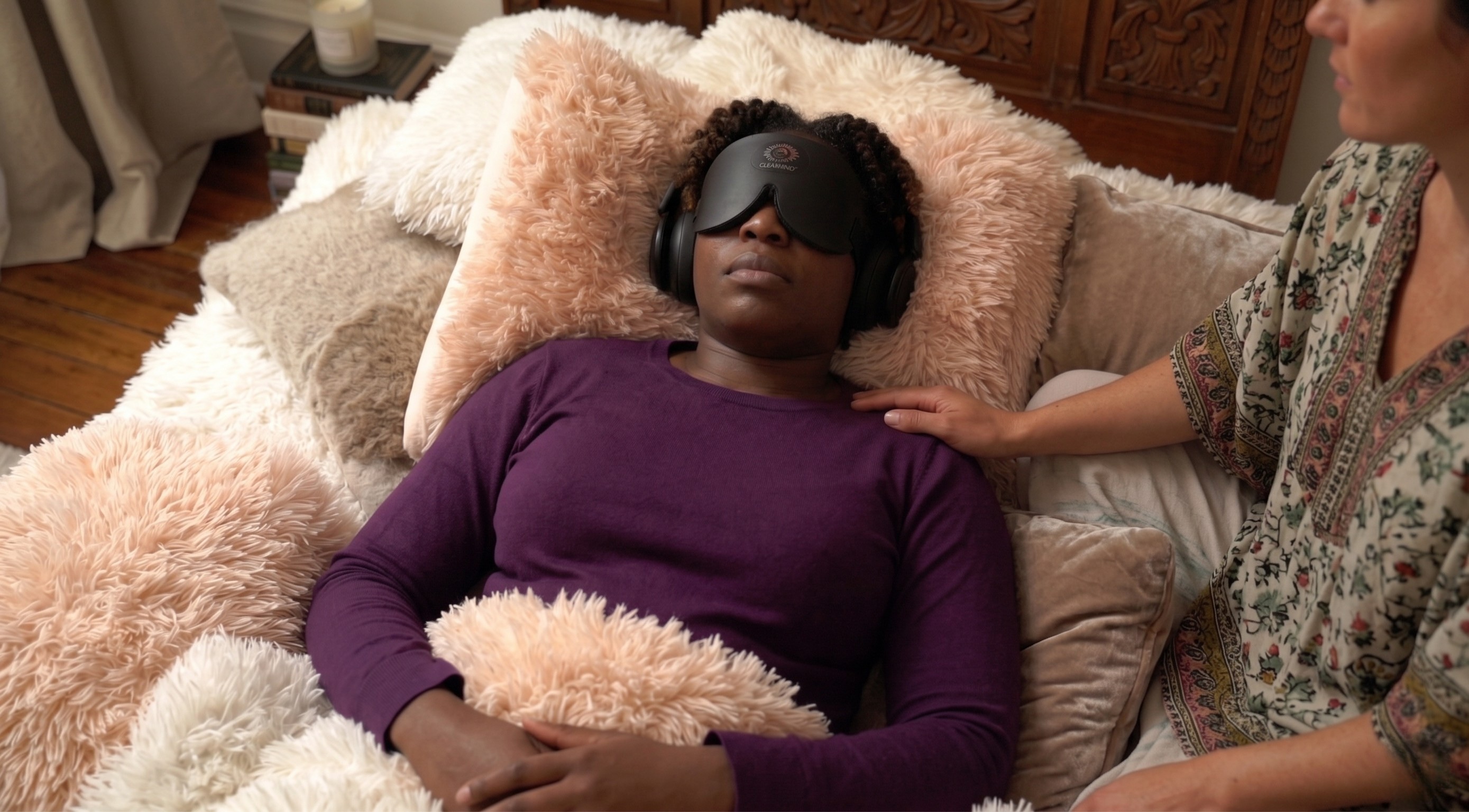 Client in eye mask and headphones during a ketamine ceremony at AWKN Ranch
